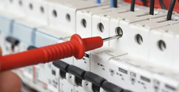 Electrical contractor testing circuit breakers during electrical repair in Jones, OK