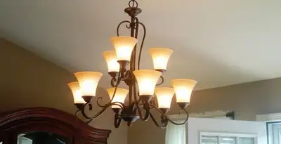 Classic ceiling chandelier installation with warm lighting in Oklahoma City, OK