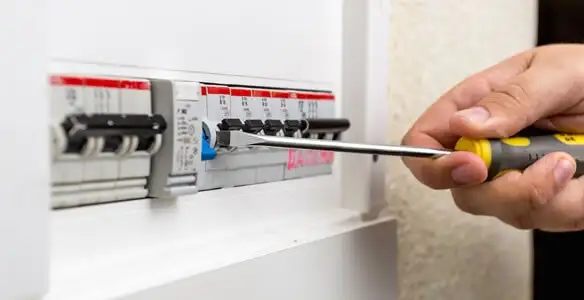 electrical panel upgrade service showing technician adjusting circuit breakers during system upgrade in Oklahoma City, OK