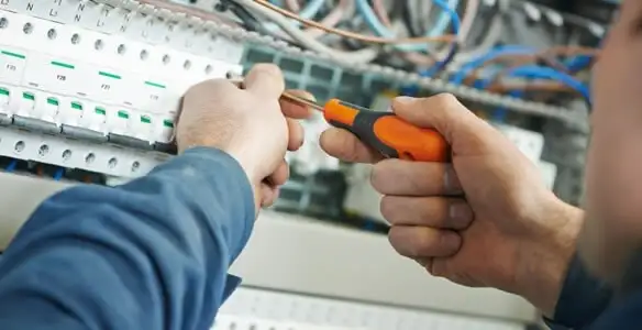 electrical service showing licensed electrician performing electrical panel maintenance and adjustments in Oklahoma City, OK