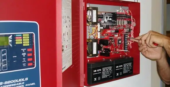 fire alarm installation service showing technician configuring fire alarm control panel in Oklahoma City, OK