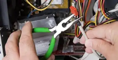 Licensed electrical contractor performing electrical repair with tools in Jones, OK