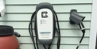 Outdoor electric vehicle charger installation on residential wall in Oklahoma City, OK