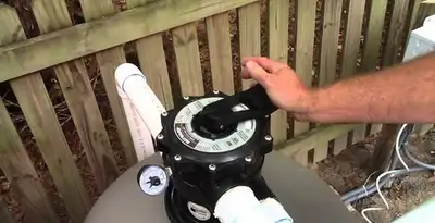 pool pumps service showing professional adjustment of pool pump control system in Oklahoma City, OK