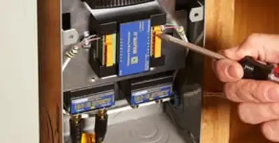 Whole home surge protection device being installed by a licensed electrician to protect electrical systems in Oklahoma City, OK